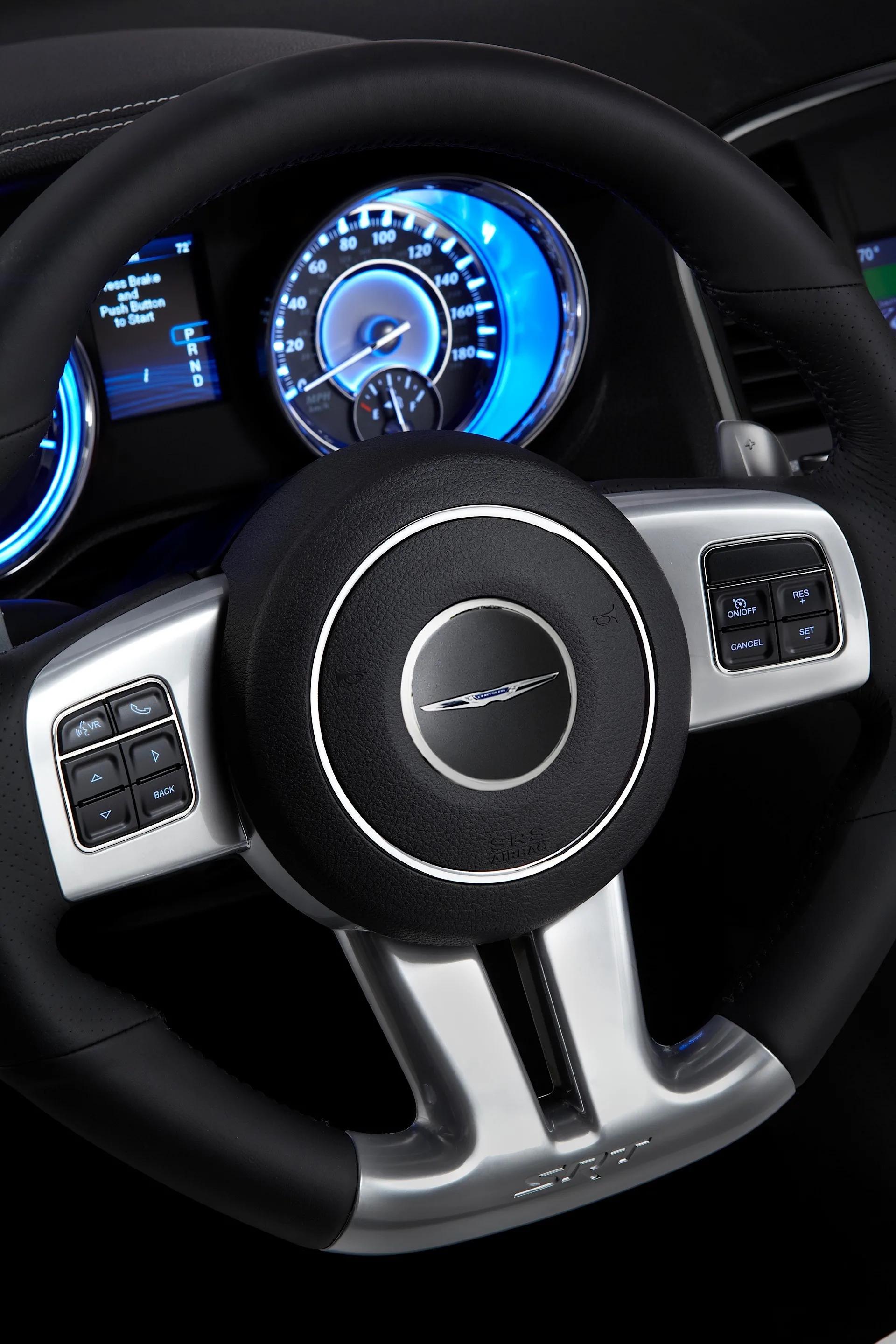 Leather-wrapped, heated, SRT-exclusive steering wheel features a unique rim section with a flattened bottom surface showing the SRT logo. Standard paddle shift controls flank both sides of the new contoured palm rests while all audio and Electronic Vehicle Information Center (EVIC) controls are accessible from the horizontal spokes on the steering wheel.