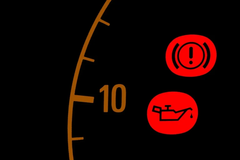 Red oil warning light illuminated on a car dashboard indicating a potential engine oil issue